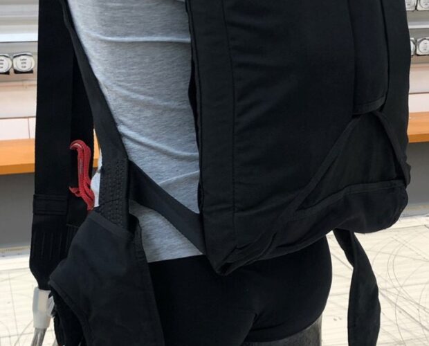 Black wearable backpack prototype with exposed wiring
